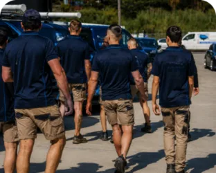 Plumbers walking to their service vans on a Bringelly job